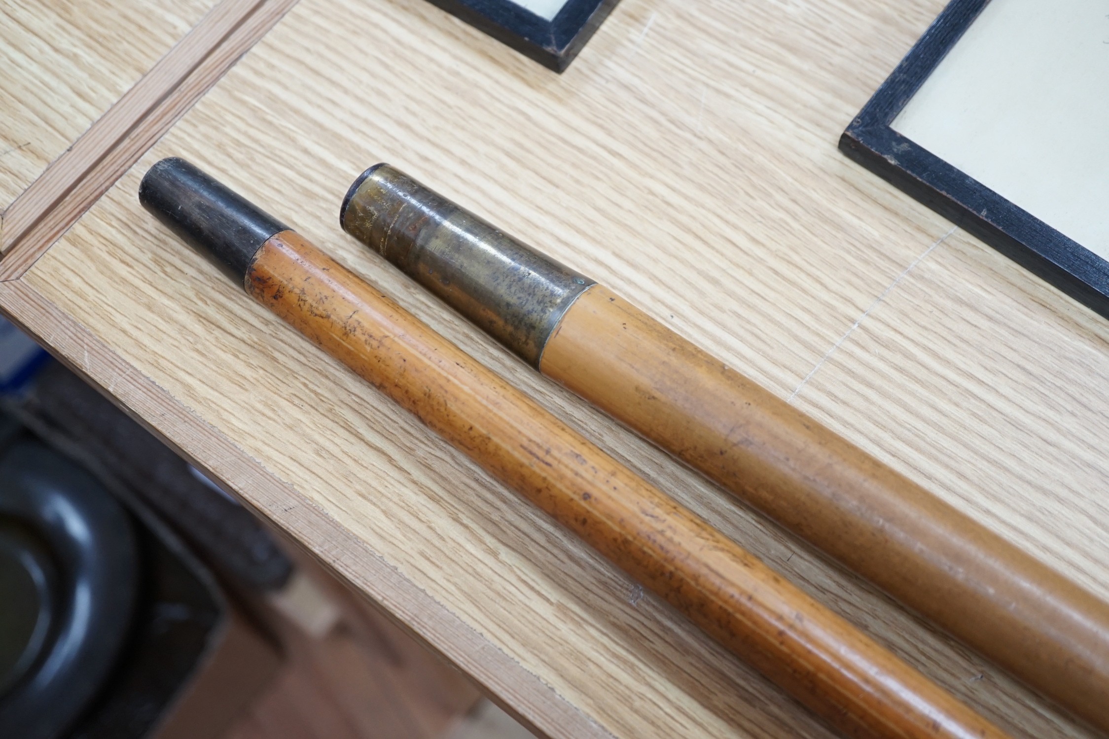 Two 19th century malacca walking canes: one with an Indian inspired 9ct gold handle, the other with a silver embossed handle, gold handled cane 92 cms long